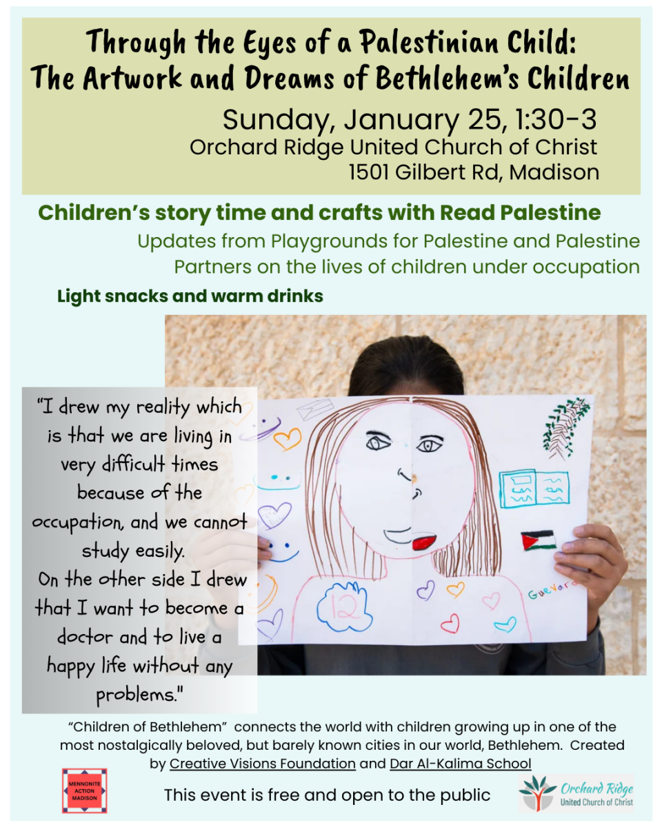 A child holds their artwork in front of their face.